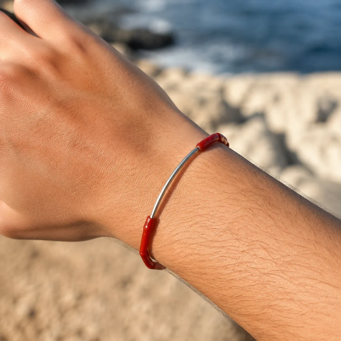 Bracelet Alba porté au bord de la Méditerranée — bijou en corail rouge unisexe AMAYAS
